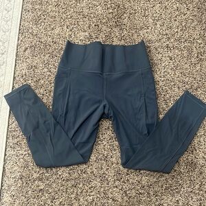 Athleta salutation stash pocket II 7/8 tight. Never worn, tags removed.